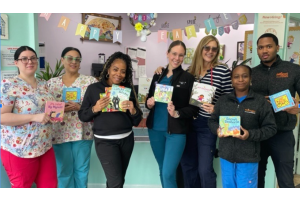 ROR team members holding up copies of Barefoot books