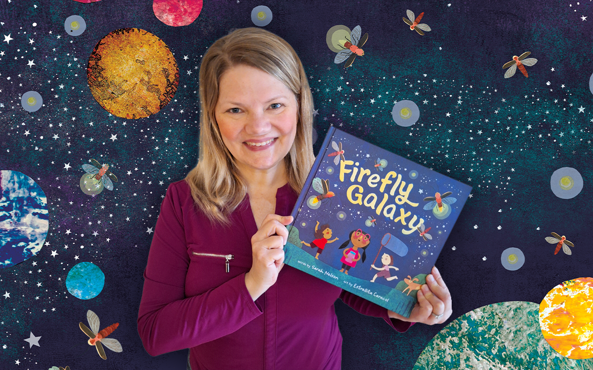 Author Sarah Nelson holding her new children's book, Firefly Galaxy