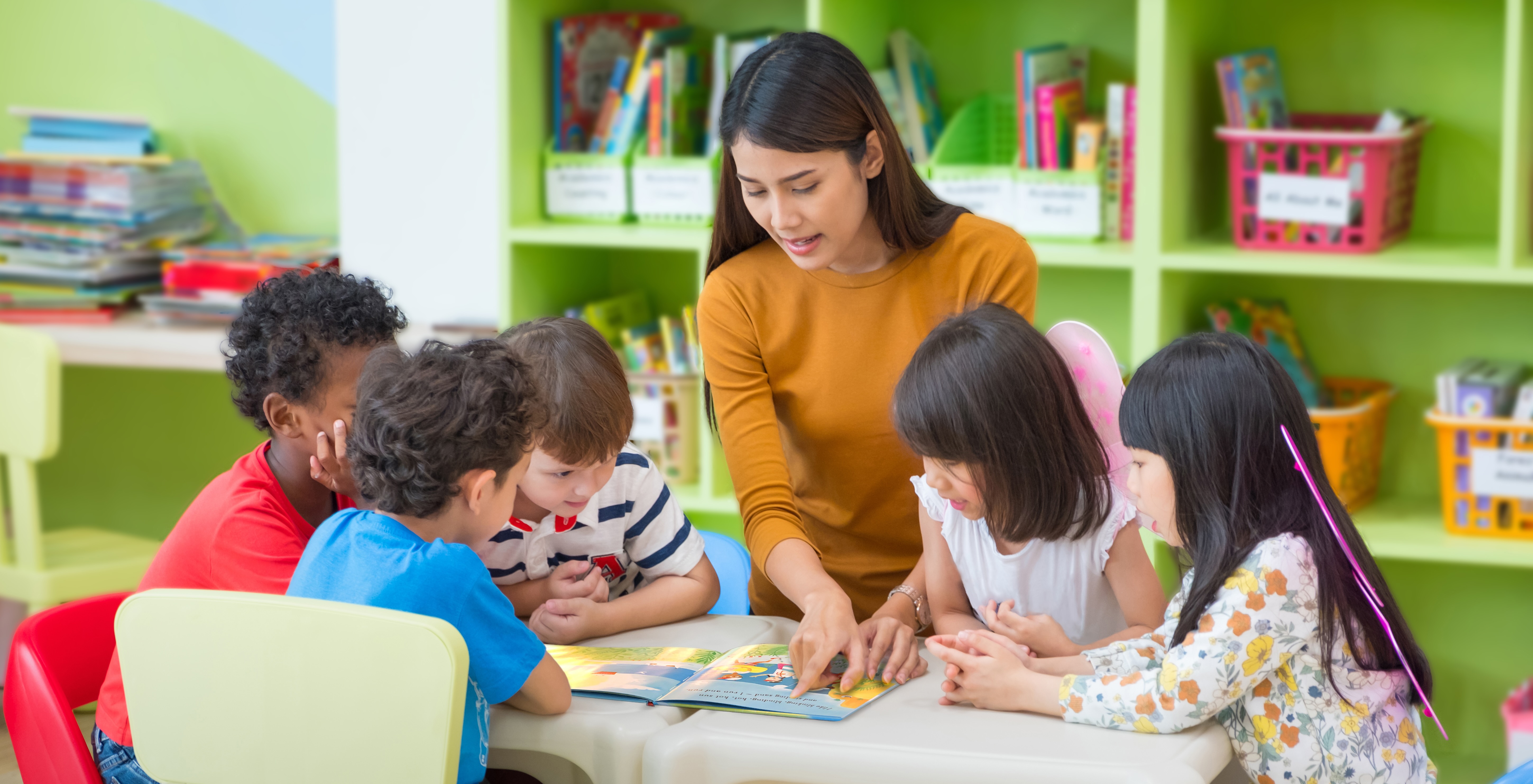 A teacher reading Barefoot Books: