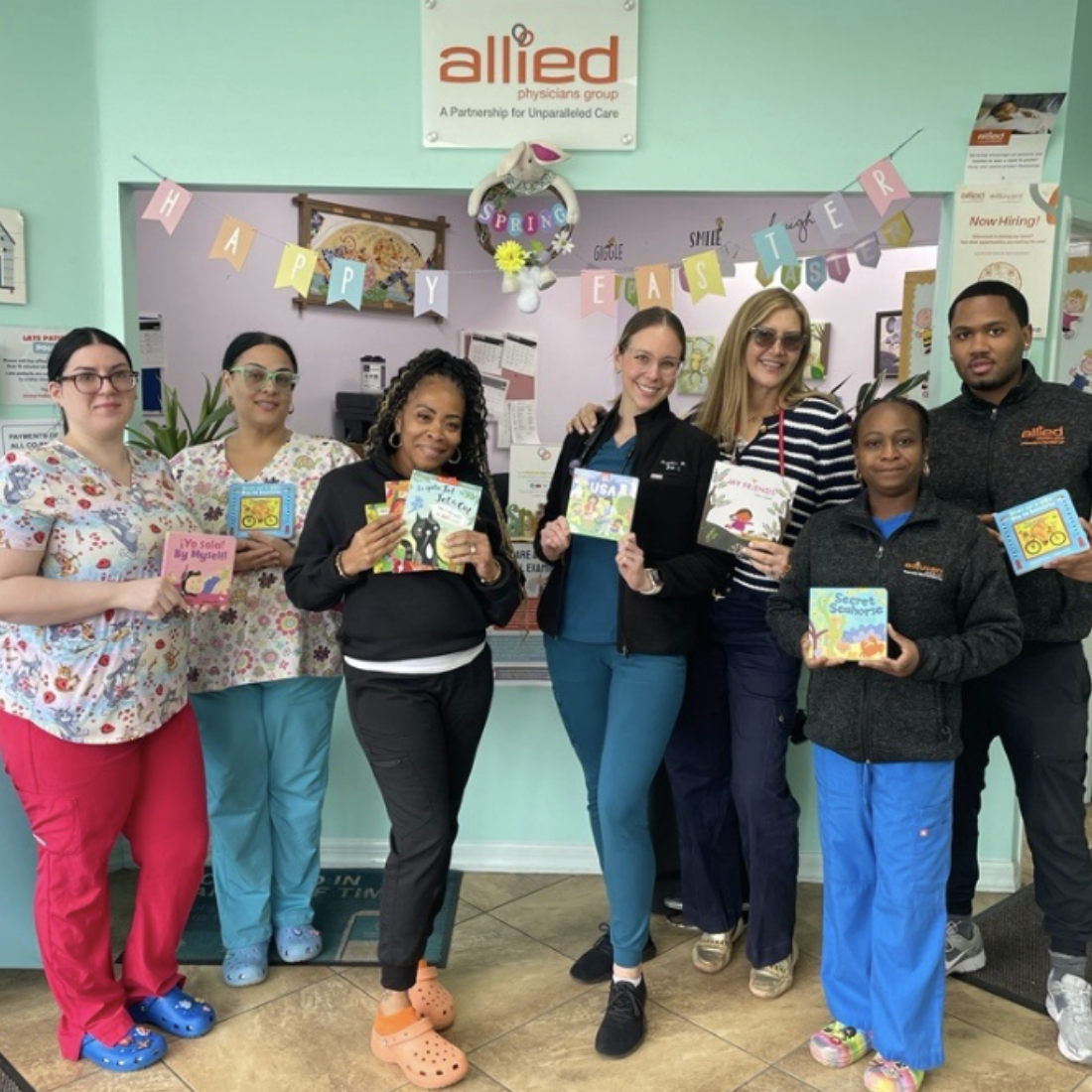 ROR staff members holding up copies of Barefoot Books