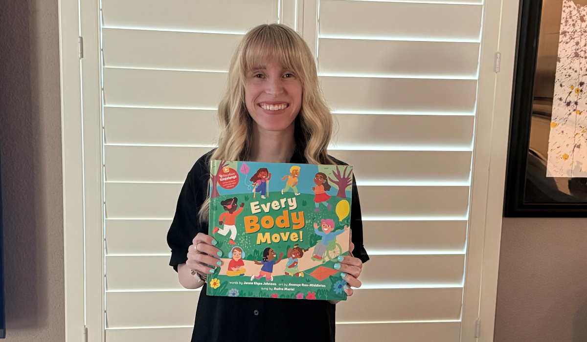 Author Jenna Johnson holding up her book, Every Body Move!