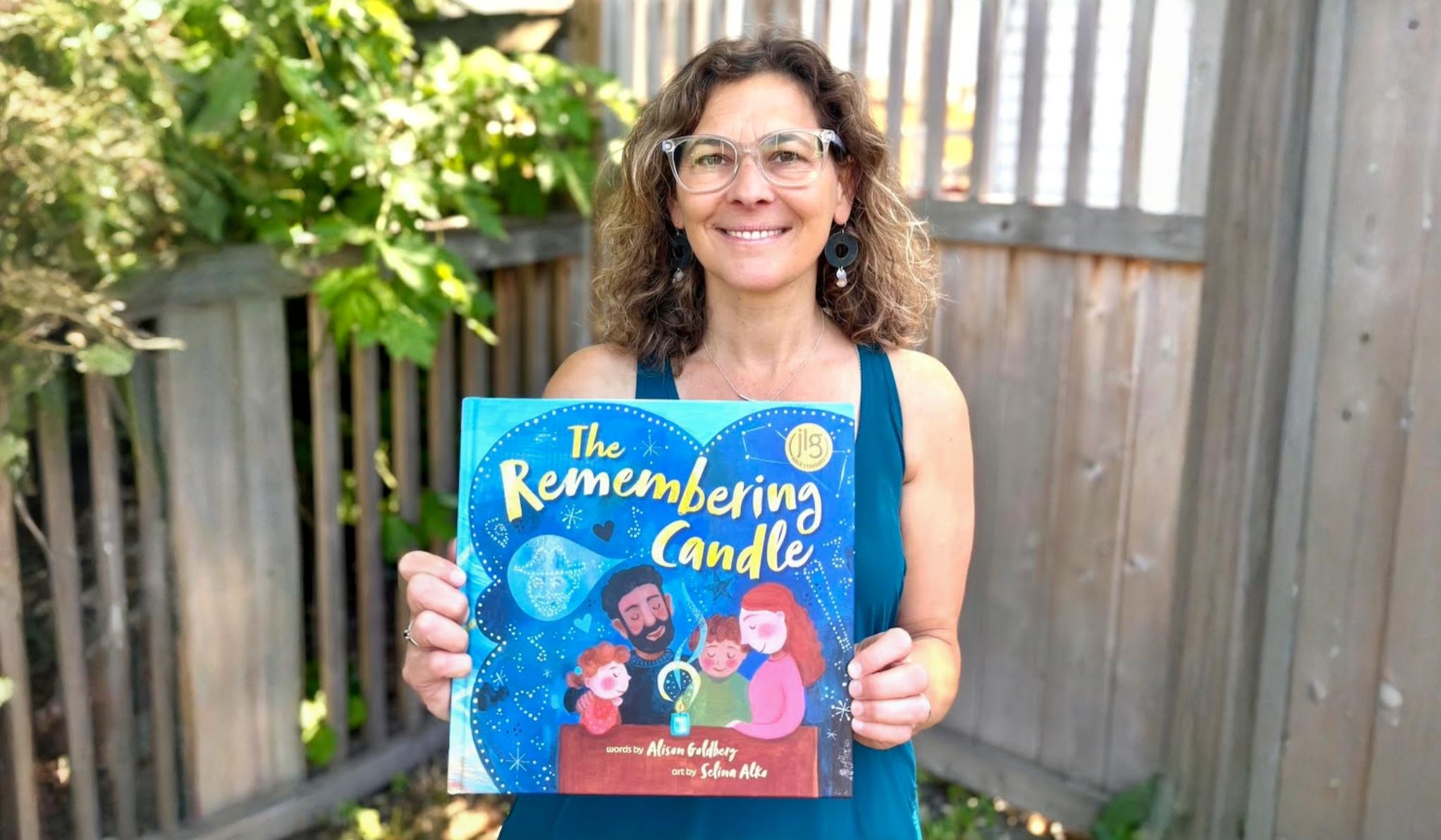 Author holding up her book: "The Remembering Candle"