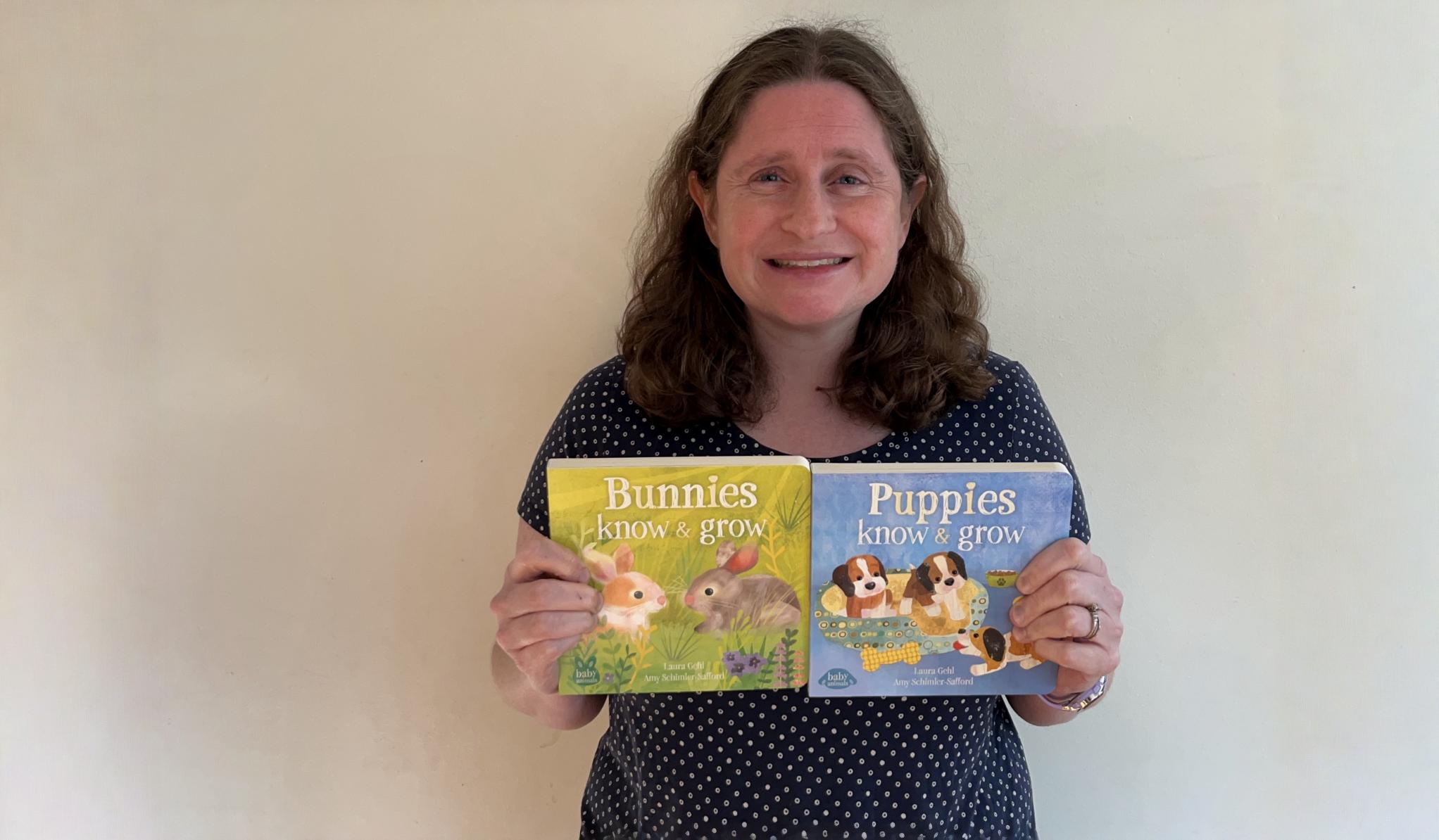 Author Razeena Laura Gehl holding up her books, Bunnies Know & Grow and Puppies Know & Grow
