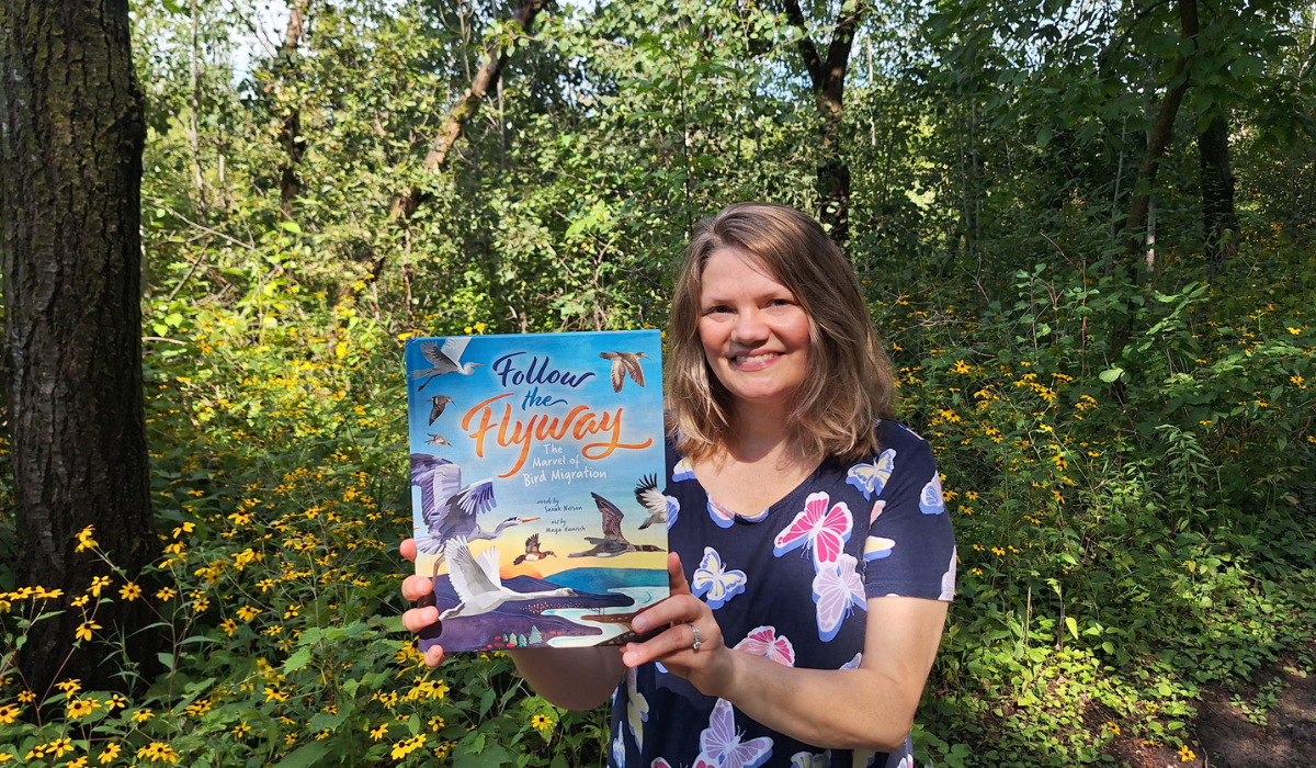 Author holding up her book: Follow the Flyway